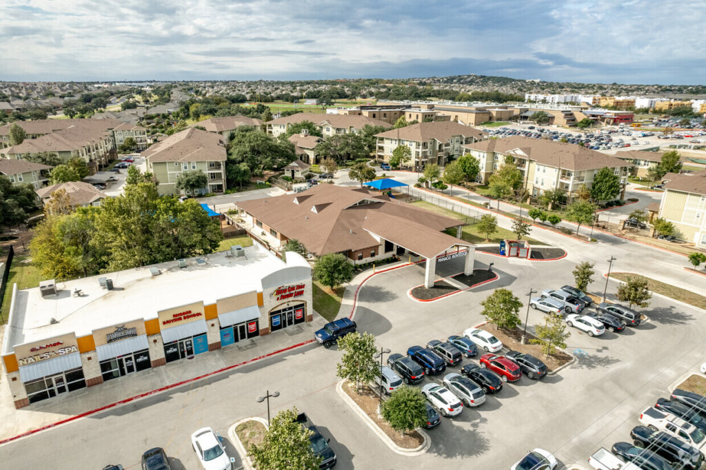 Aerial view of property near retail and residential development
